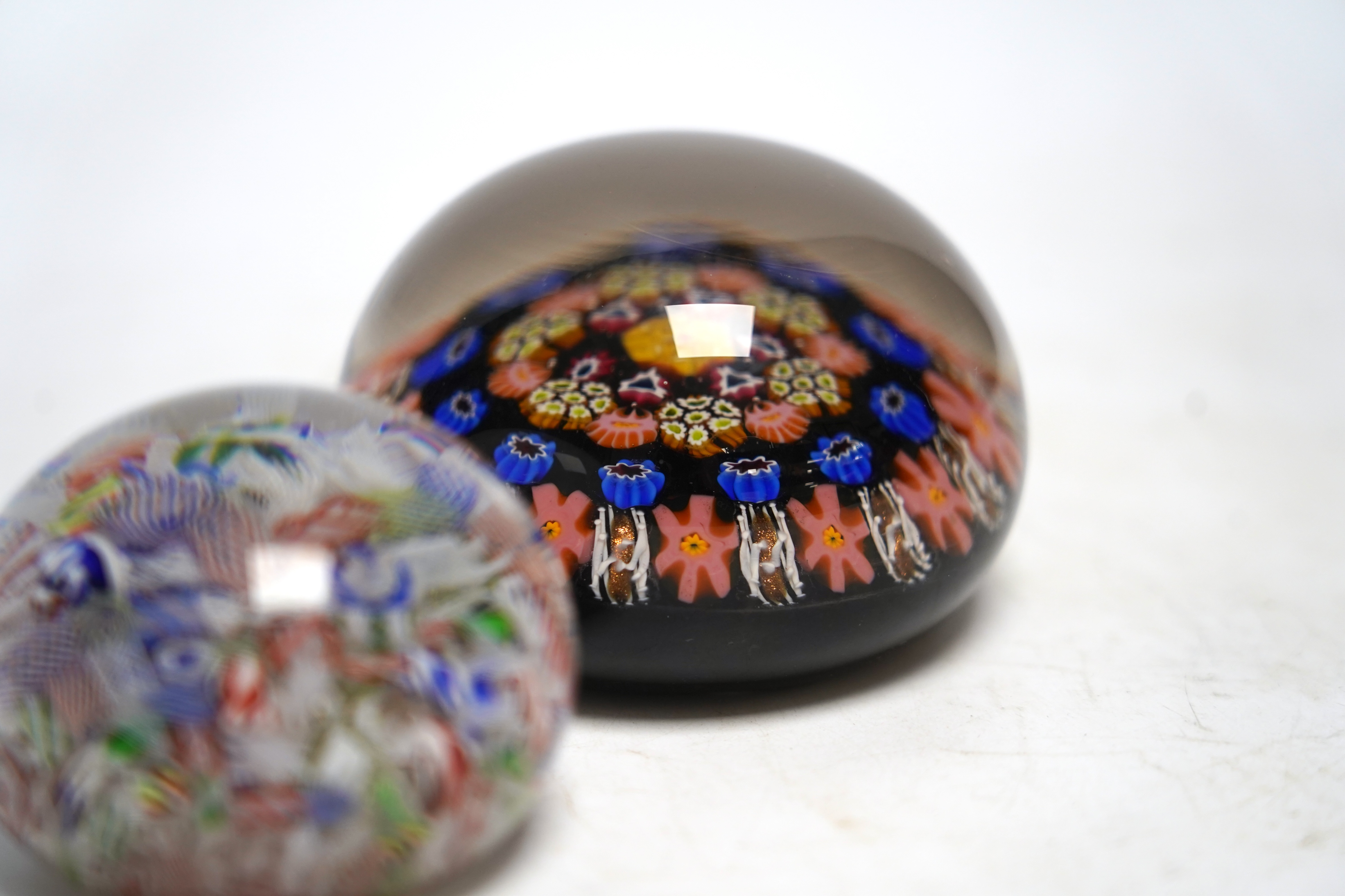 A mid 19th century French scattered cane paperweight and another, largest 8cm diameter